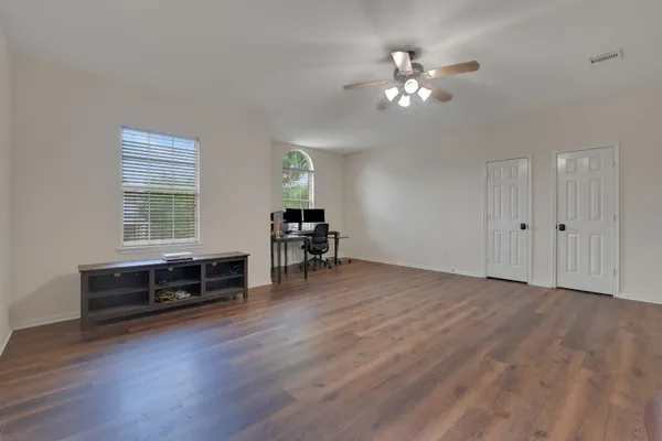 a view of a livingroom with furniture chandelier fan and hardwood floor