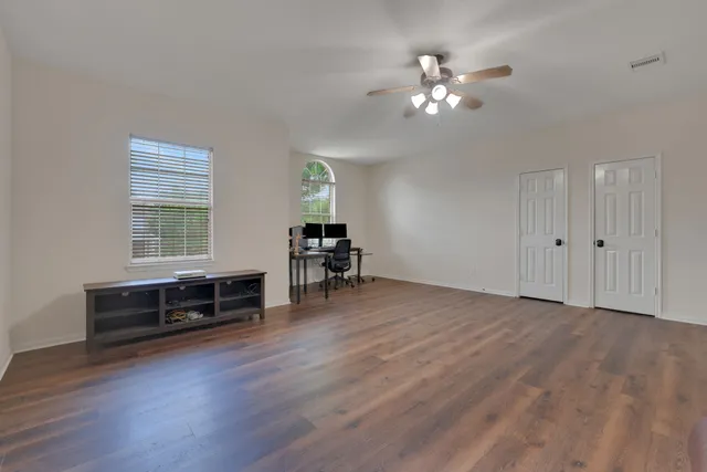 a view of a livingroom with furniture chandelier fan and hardwood floor