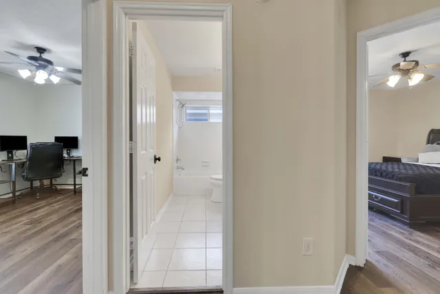 a view of a hallway with workspace and closet area