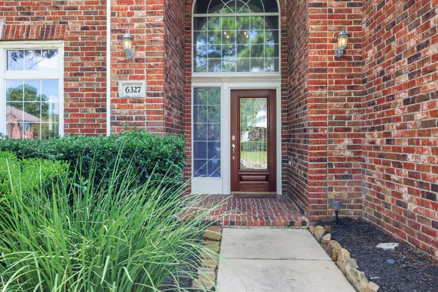 a view of a brick house with windows