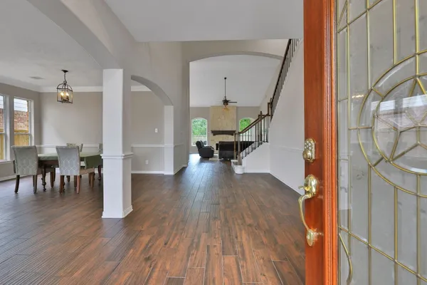 a view of a living room and dining room with wooden floor
