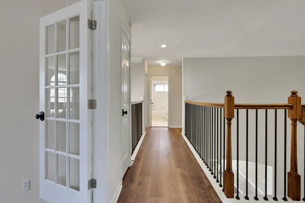a view of a hallway with wooden floor