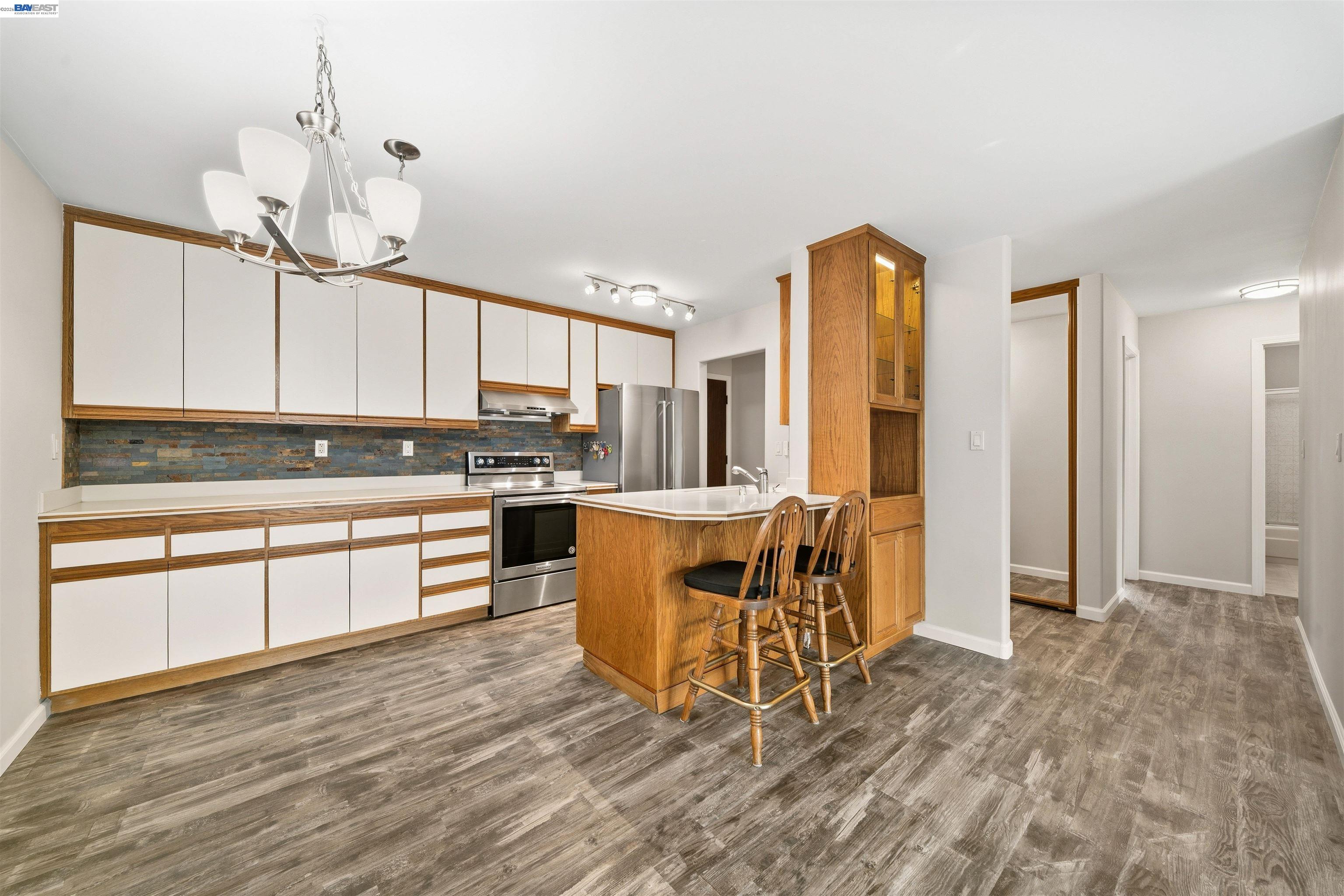 960 Shorepoint Court, Unit 116 Alameda, CA 94501 - Photo 4 of 20 a kitchen with stainless steel appliances granite countertop a stove a sink dishwasher and a refrigerator with wooden floor