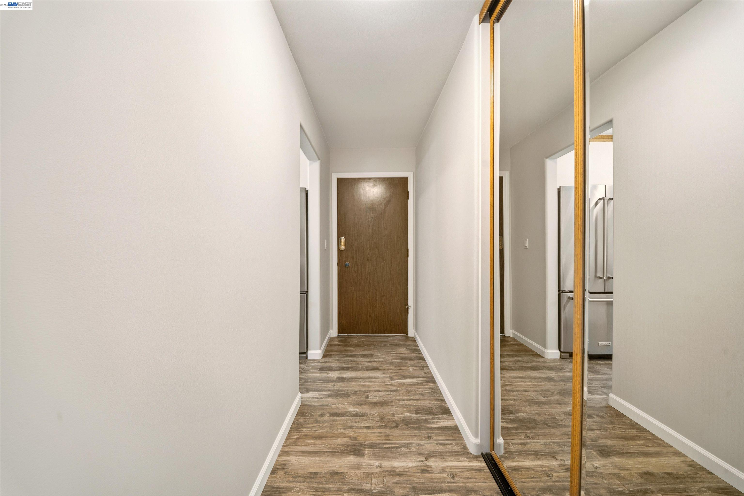 960 Shorepoint Court, Unit 116 Alameda, CA 94501 - Photo 6 of 20 a view of a hallway with wooden floor and staircase