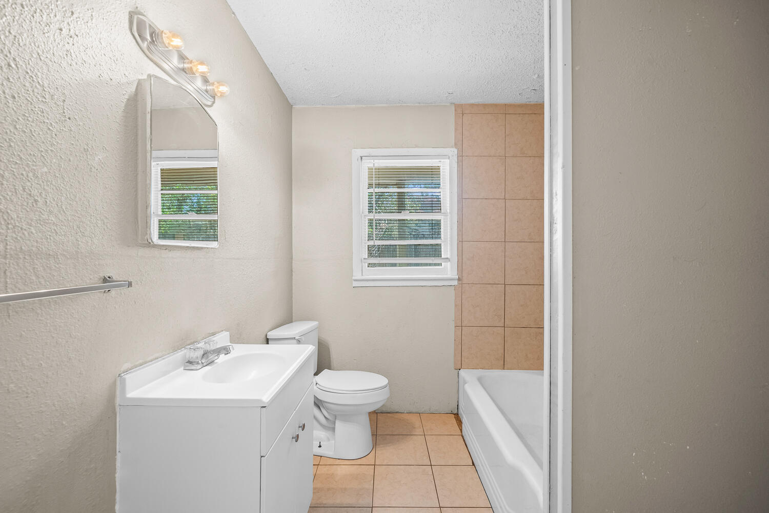 1603 27th Street, Unit A Lubbock, TX 79411 - Photo 10 of 13 a bathroom with a sink a toilet and shower