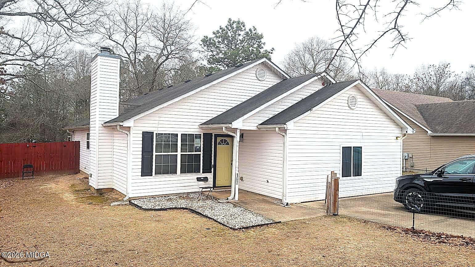 a view of a house with a patio and backyard