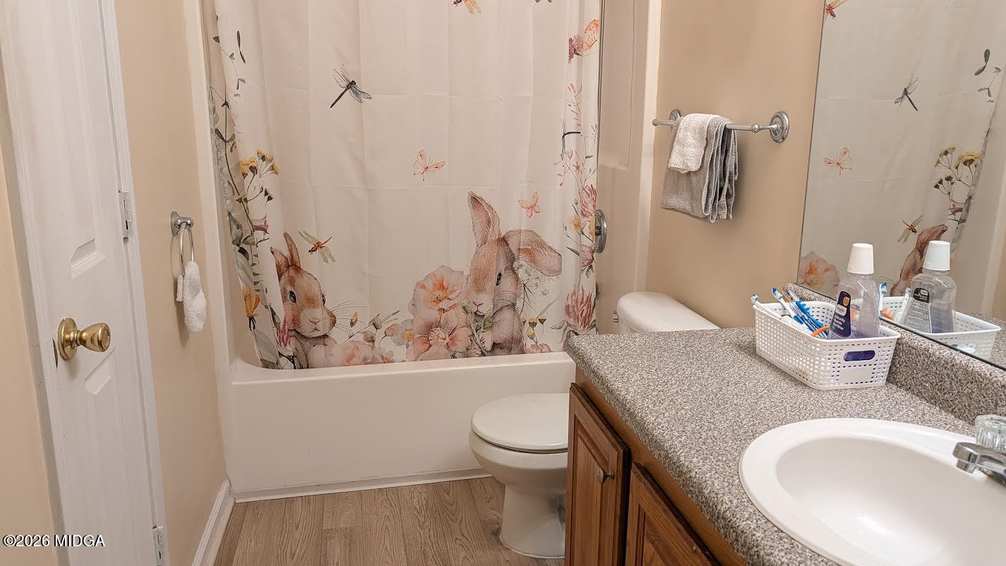 167 Apple Valley Road Macon, GA 31217 - Photo 19 of 22 a bathroom with a granite countertop sink toilet and a mirror