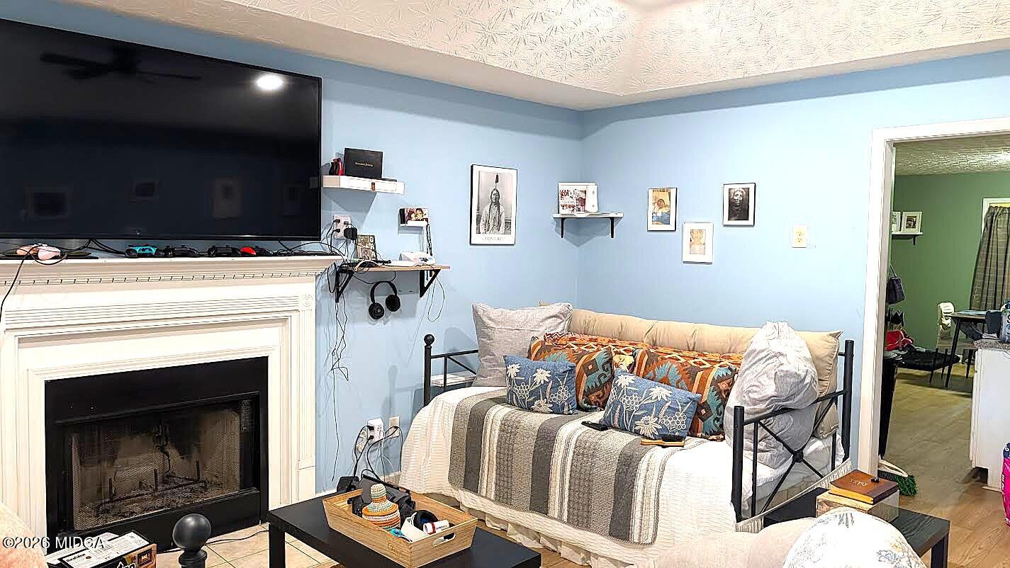 167 Apple Valley Road Macon, GA 31217 - Photo 3 of 22 a bedroom with a bed and a fireplace