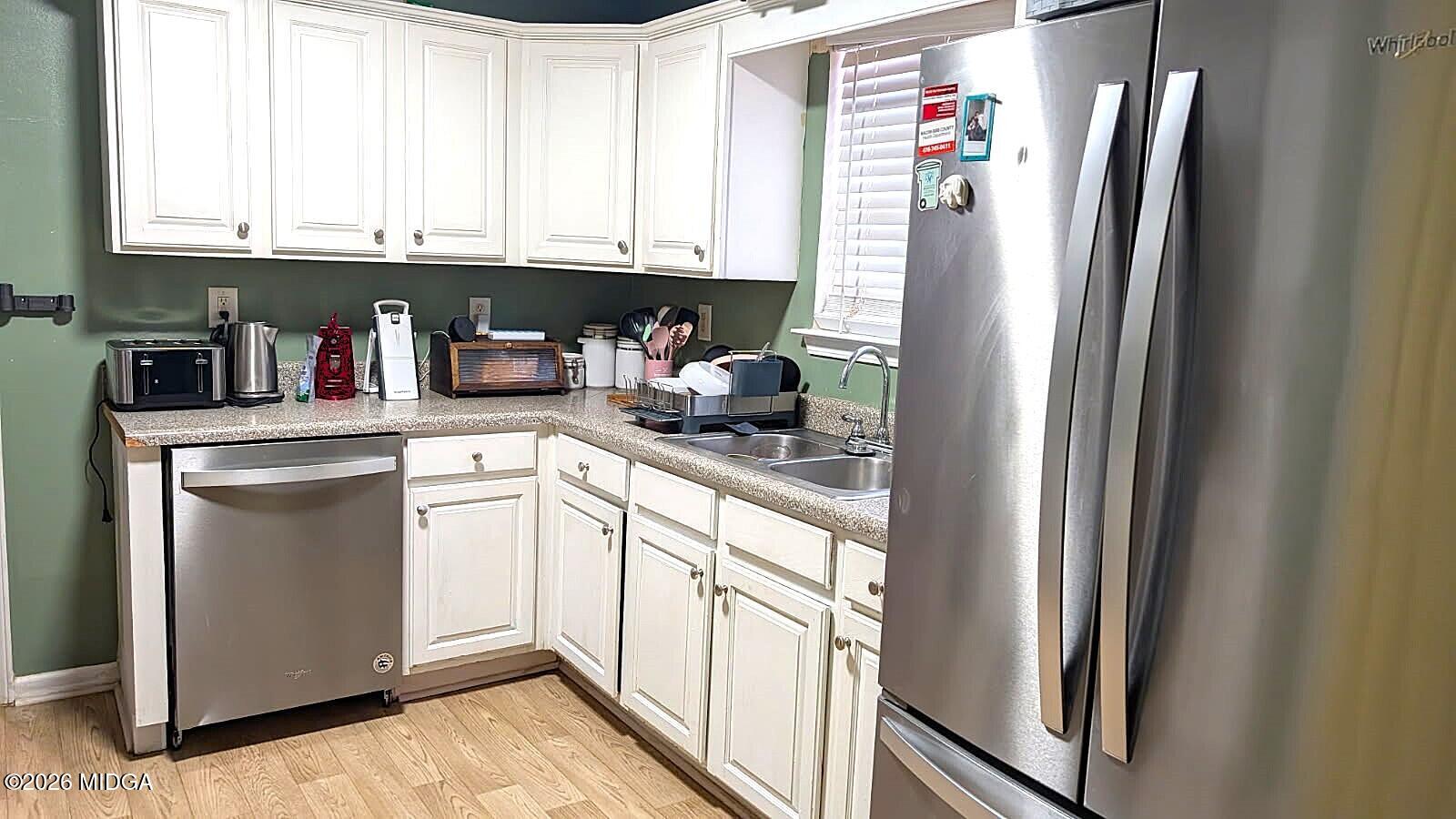 167 Apple Valley Road Macon, GA 31217 - Photo 4 of 22 a kitchen with stainless steel appliances granite countertop a refrigerator and a sink