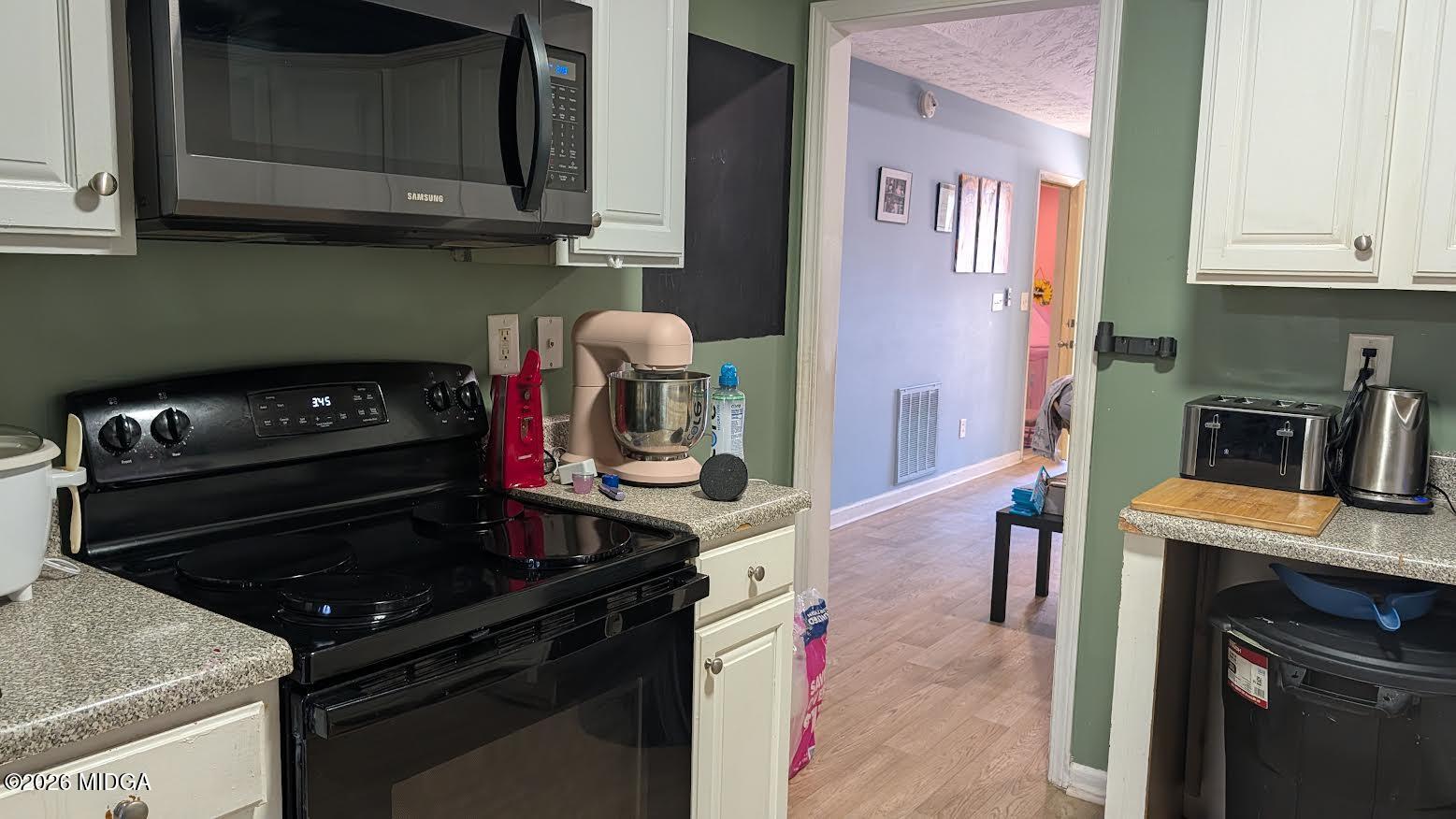 167 Apple Valley Road Macon, GA 31217 - Photo 5 of 22 a kitchen with a stove and a microwave