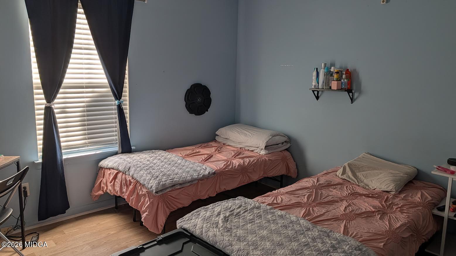 167 Apple Valley Road Macon, GA 31217 - Photo 9 of 22 a bedroom with two beds and wooden floor