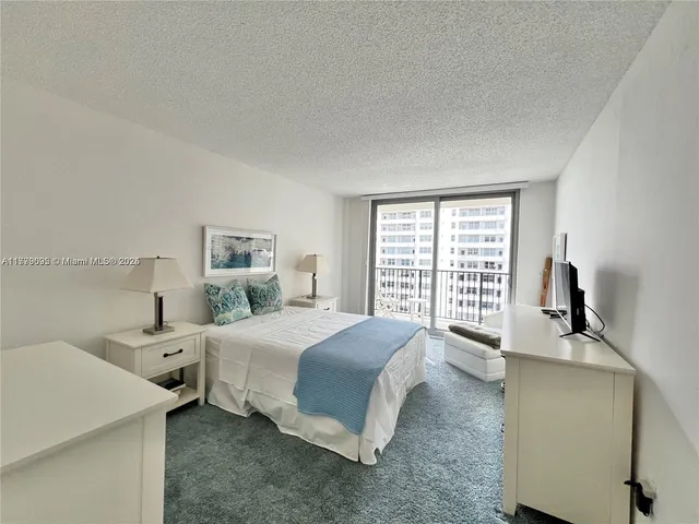 a spacious bedroom with a bed and a large window