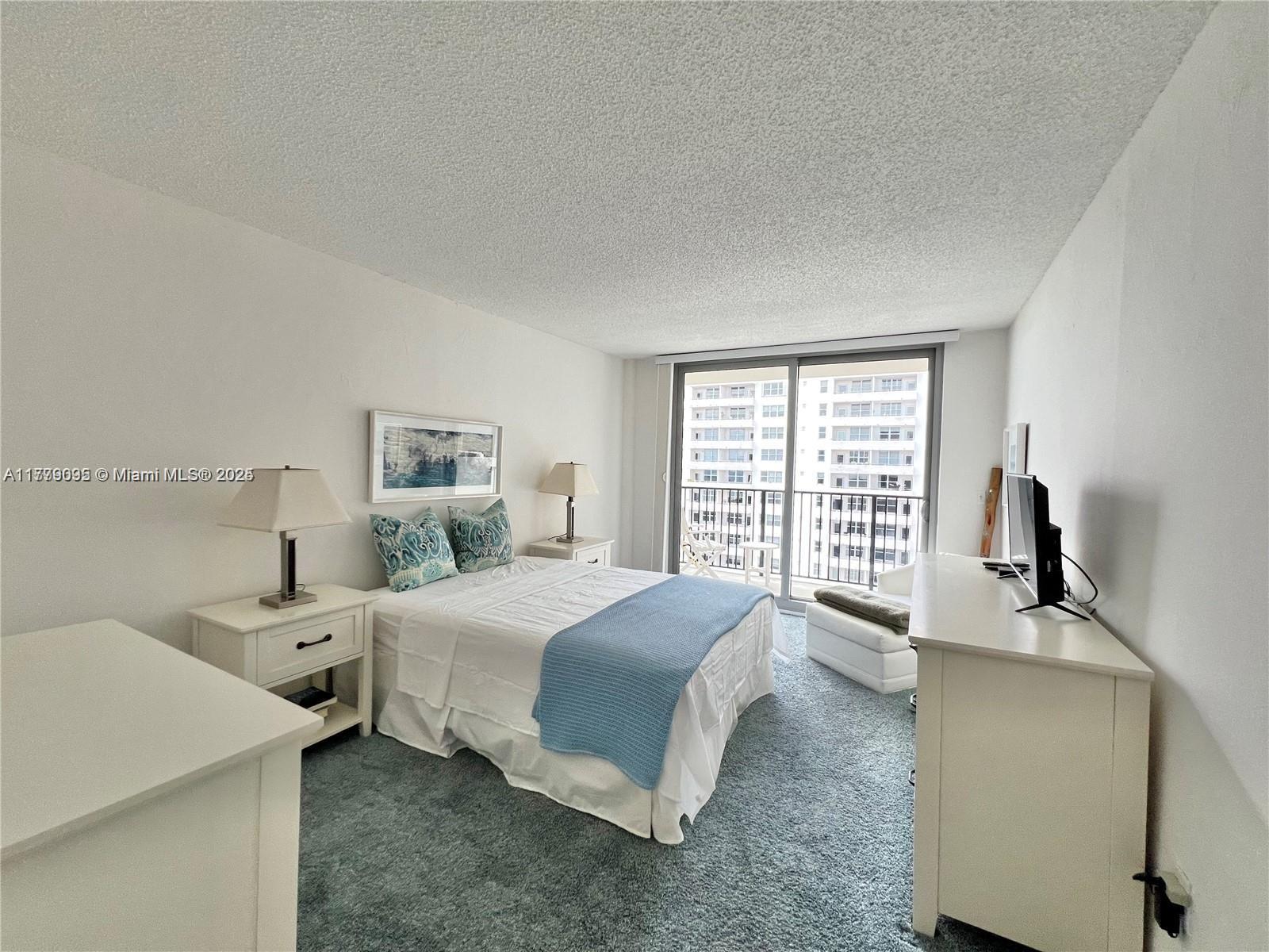 9273 Collins Avenue, Unit 801 Surfside, FL 33154 - Photo 11 of 15 a spacious bedroom with a bed and a large window