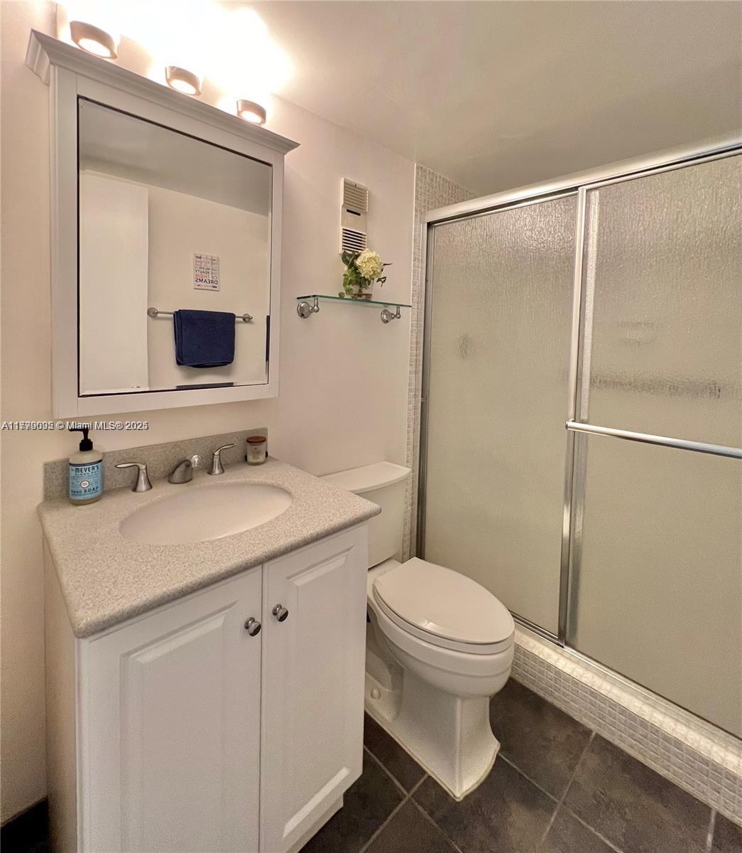 9273 Collins Avenue, Unit 801 Surfside, FL 33154 - Photo 13 of 15 a bathroom with a sink toilet and shower