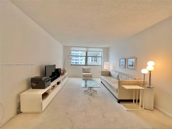 a kitchen with a refrigerator a stove and white cabinets