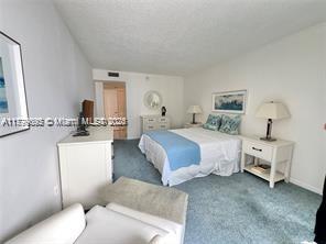 9273 Collins Avenue, Unit 801 Surfside, FL 33154 - Photo 6 of 15 a bedroom with bed and furniture
