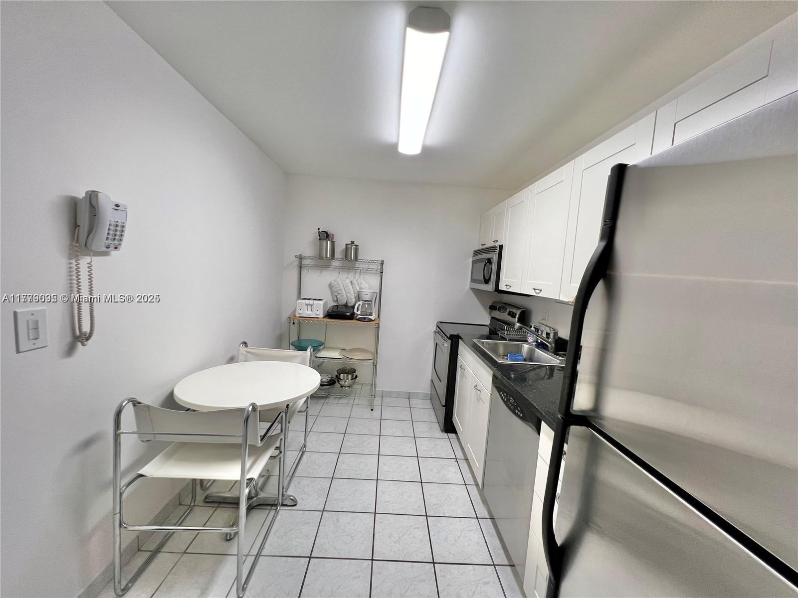 9273 Collins Avenue, Unit 801 Surfside, FL 33154 - Photo 8 of 15 a bathroom with a sink a toilet a mirror and shower