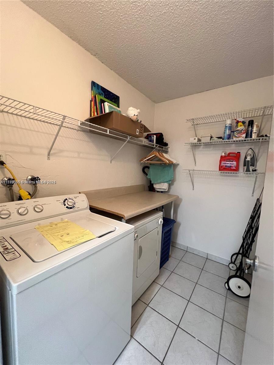 9273 Collins Avenue, Unit 801 Surfside, FL 33154 - Photo 9 of 15 a utility room with dryer and washer