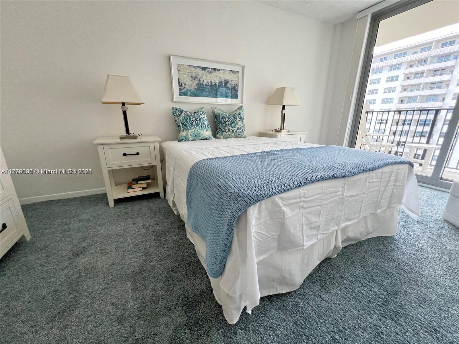 9273 Collins Avenue, Unit 801 Surfside, FL 33154 - Photo 10 of 15 a bed sitting in a bedroom next to a window