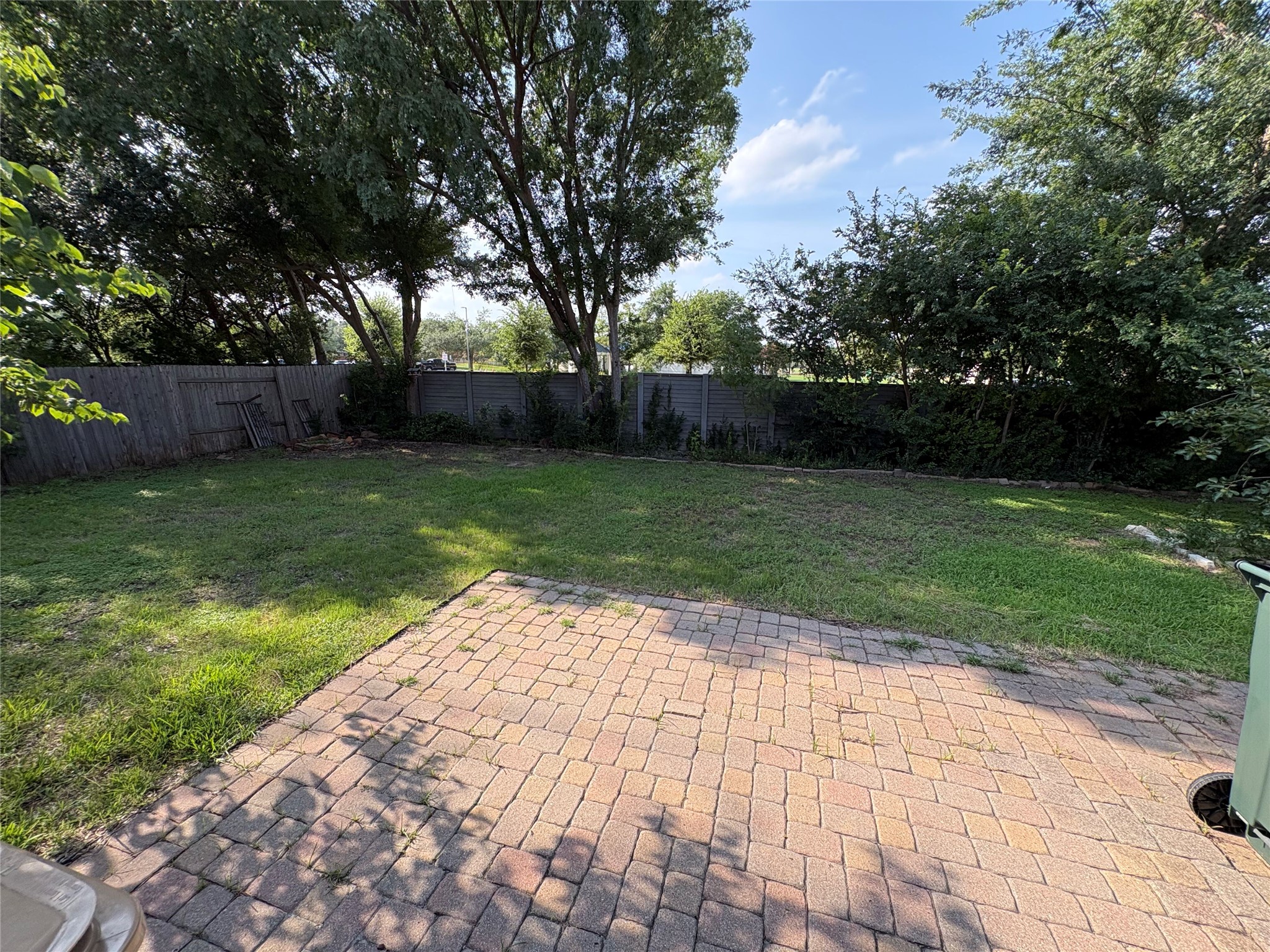 7006 Rambollet Terrace Round Rock, TX 78681 - Photo 30 of 38 A spacious backyard features a paver patio and ample green space for outdoor activities.