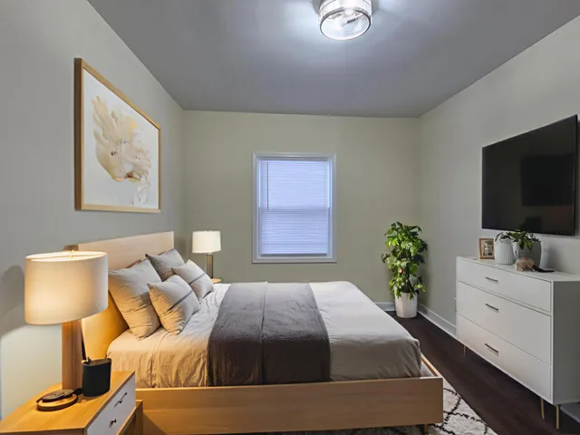 a bedroom with a bed and a flat screen tv