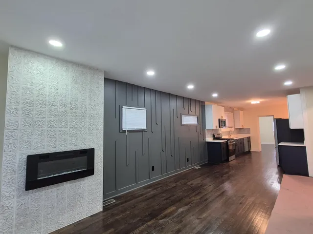 a view of a kitchen with a sink and a refrigerator