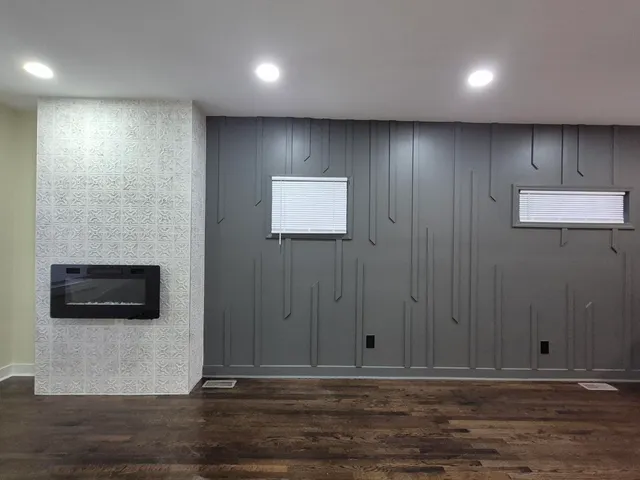 a view of a hallway with wooden floor and a fireplace