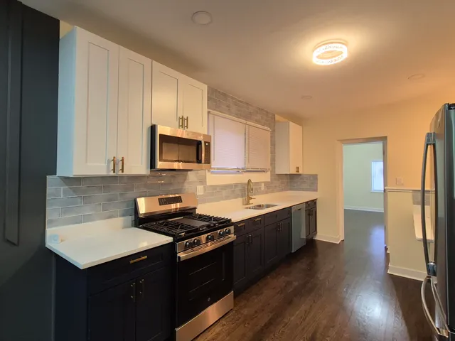 a kitchen with a sink a stove and cabinets
