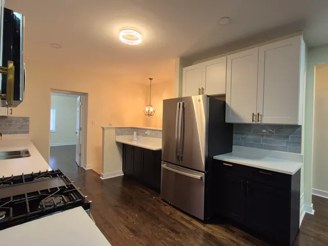 a kitchen with a refrigerator stove and cabinets