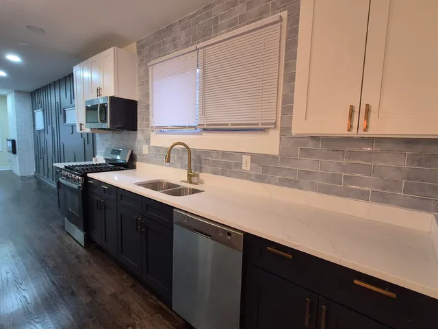 a kitchen with a sink and cabinets
