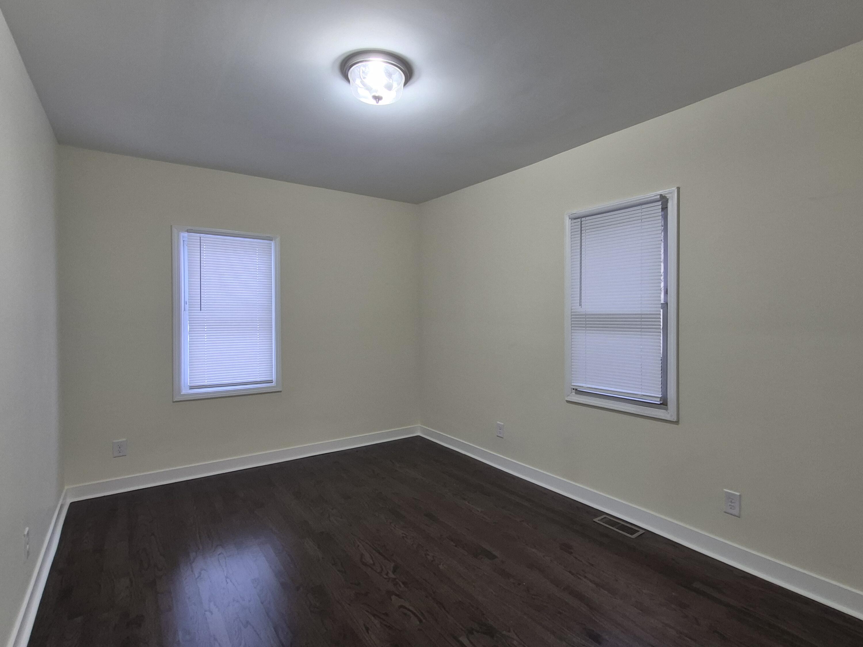 308 Pierce Street Gary, IN 46402 - Photo 10 of 25 an empty room with wooden floor and windows