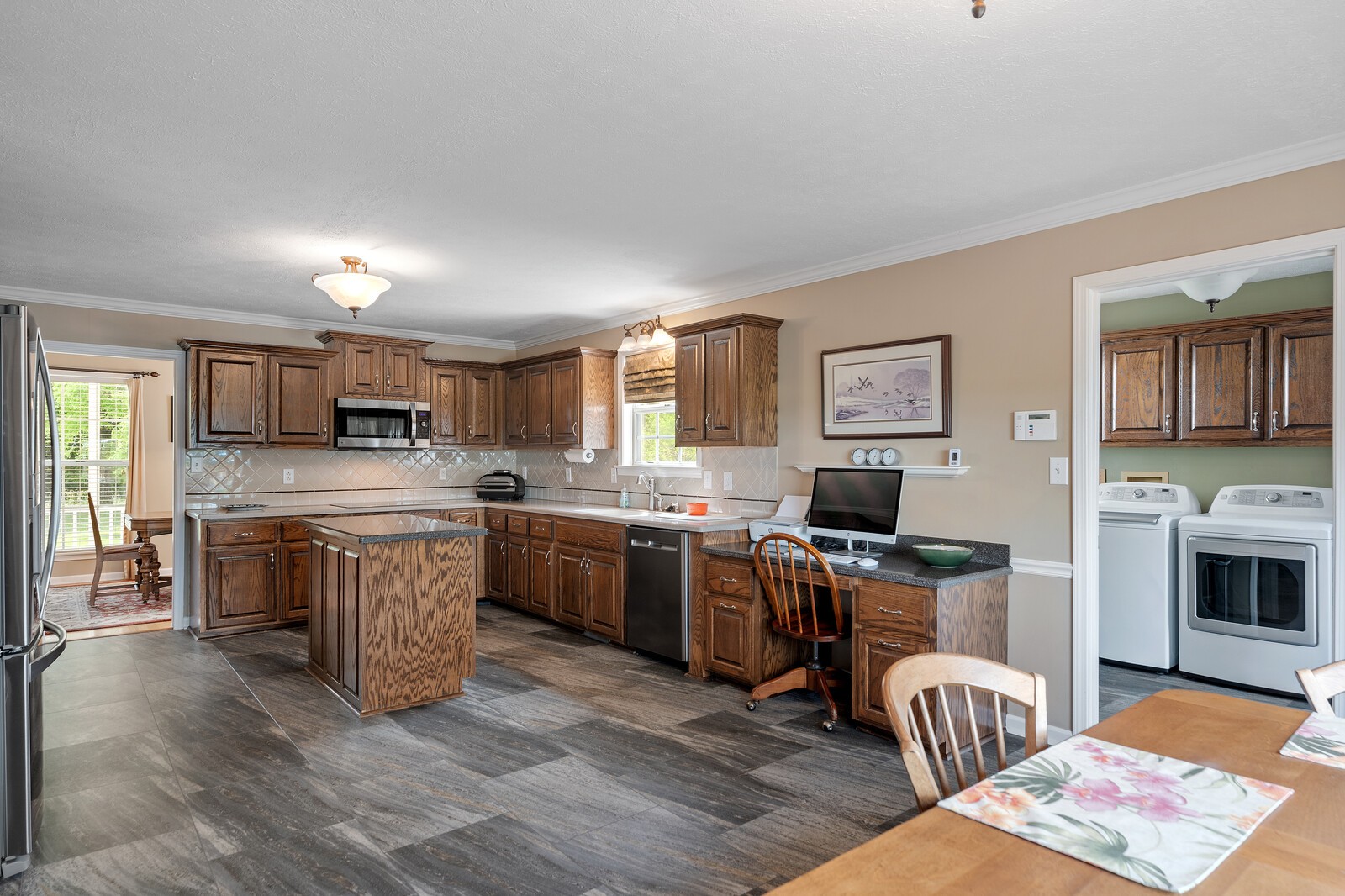6028 State Line Road Springfield, TN 37172 - Photo 24 of 45 a kitchen with stainless steel appliances granite countertop a stove top oven a sink dishwasher a dining table and chairs with wooden floor
