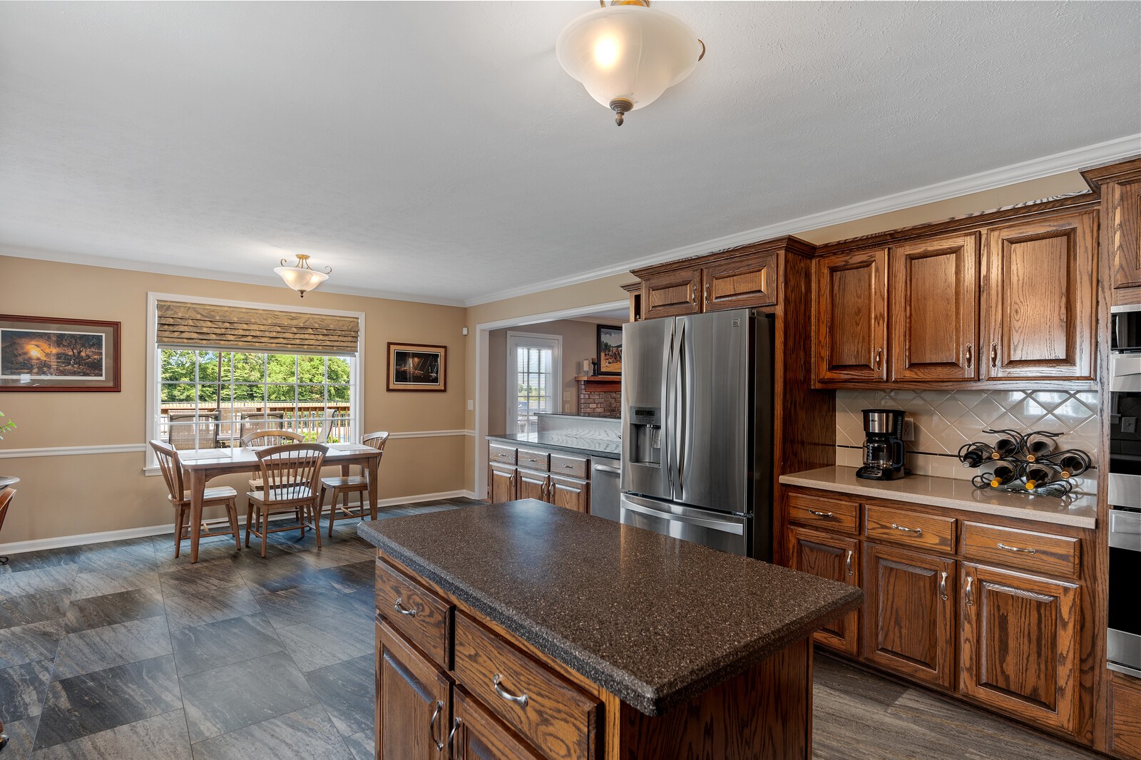 6028 State Line Road Springfield, TN 37172 - Photo 29 of 45 a kitchen with a table chairs refrigerator and cabinets