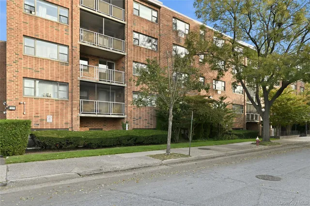 a view of a tall building next to a road