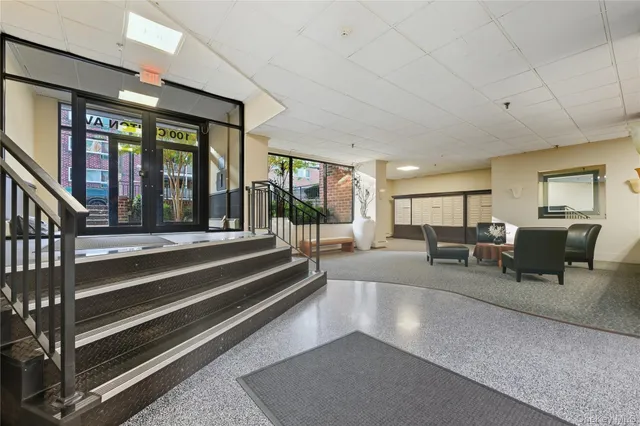 a lobby with furniture and large window
