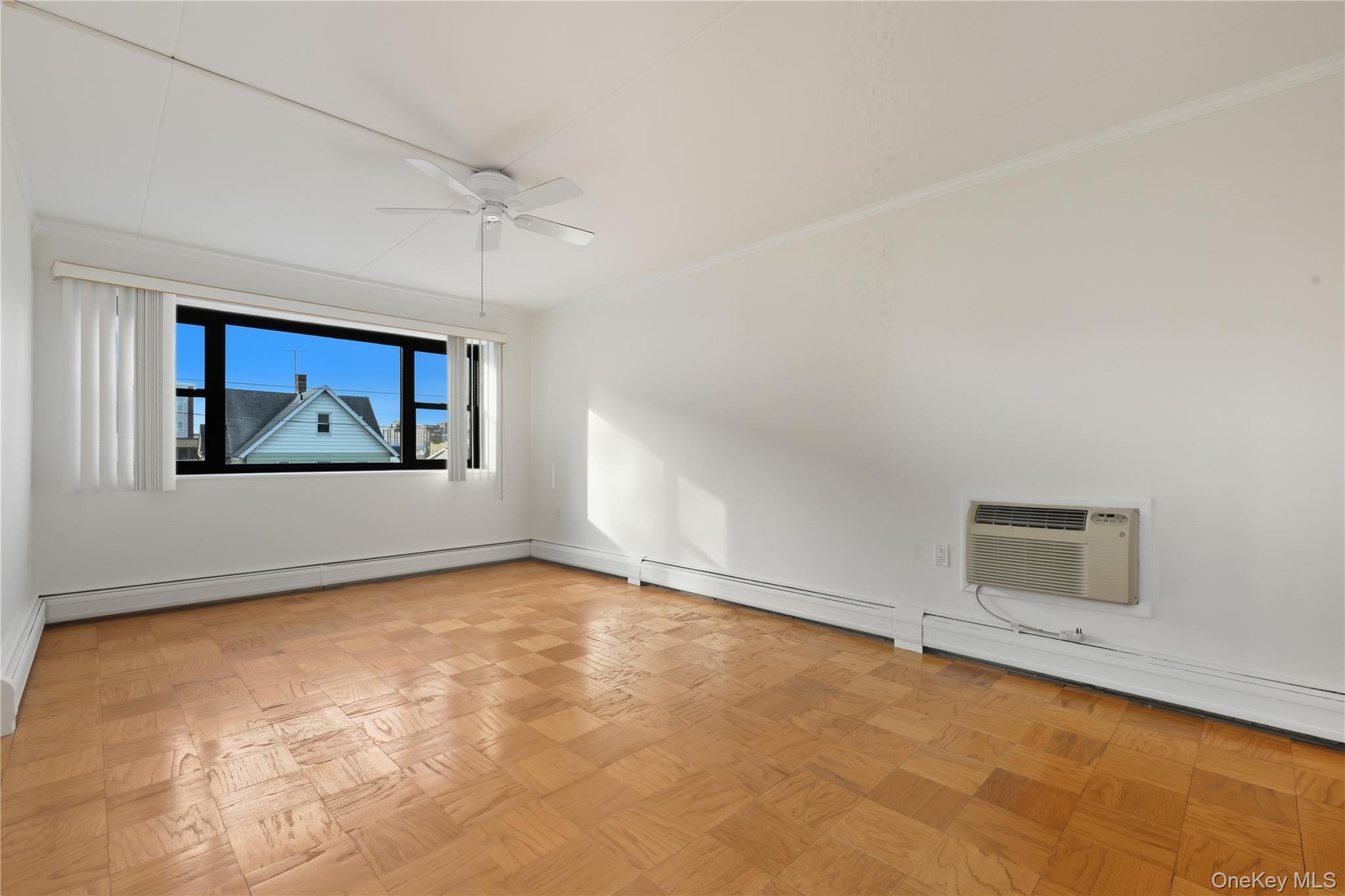 100 Clinton Avenue, Unit 2J Mineola, NY 11501 - Photo 7 of 24 an empty room with windows