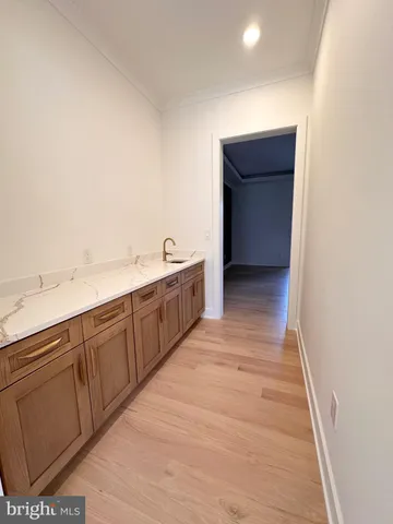 a room with a sink and cabinets
