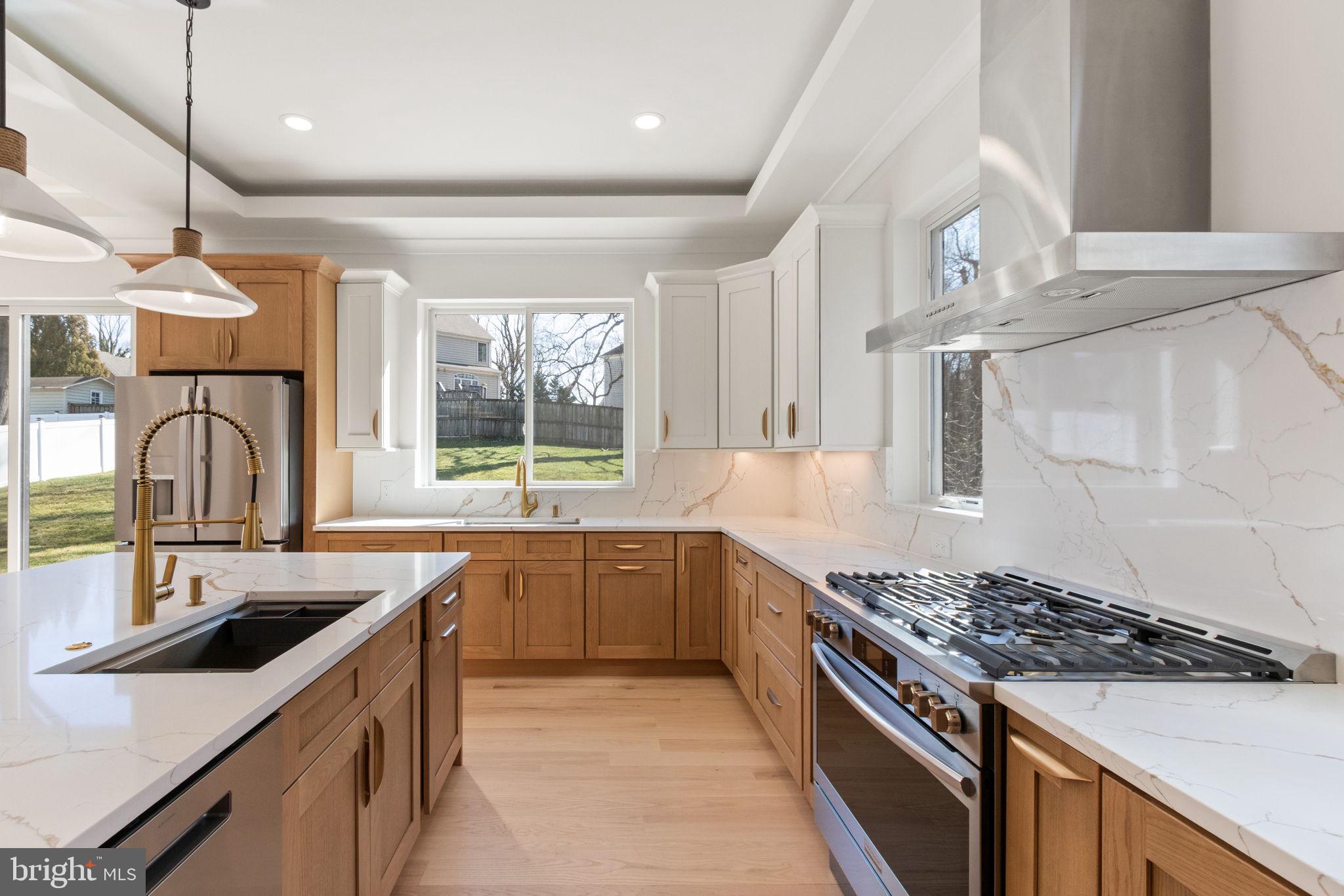 4017 Woodland Road Annandale, VA 22003 - Photo 25 of 76 a kitchen with stainless steel appliances granite countertop a sink stove and refrigerator
