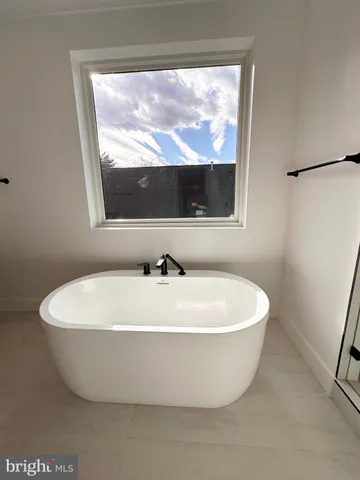 a white tub sitting next to a window
