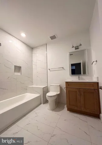a bathroom with a bathtub sink and toilet