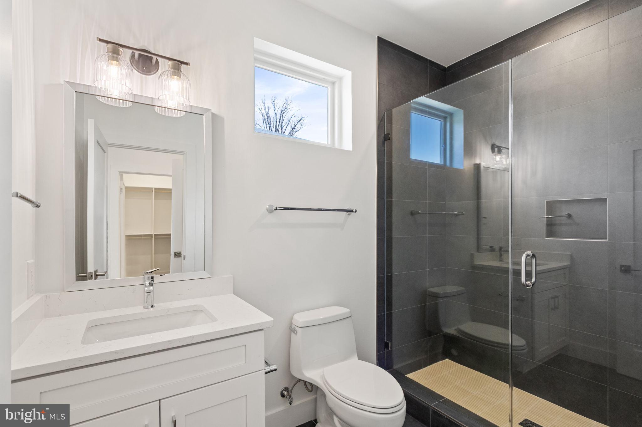 4017 Woodland Road Annandale, VA 22003 - Photo 49 of 76 a bathroom with a sink a toilet and shower