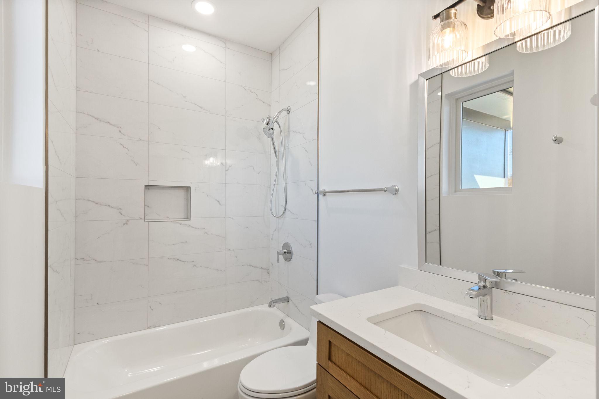 4017 Woodland Road Annandale, VA 22003 - Photo 53 of 76 a bathroom with a sink toilet tub and shower