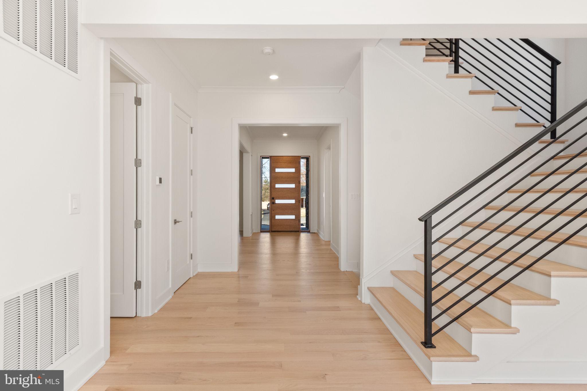 4017 Woodland Road Annandale, VA 22003 - Photo 6 of 76 a view of a hallway with wooden floor and staircase