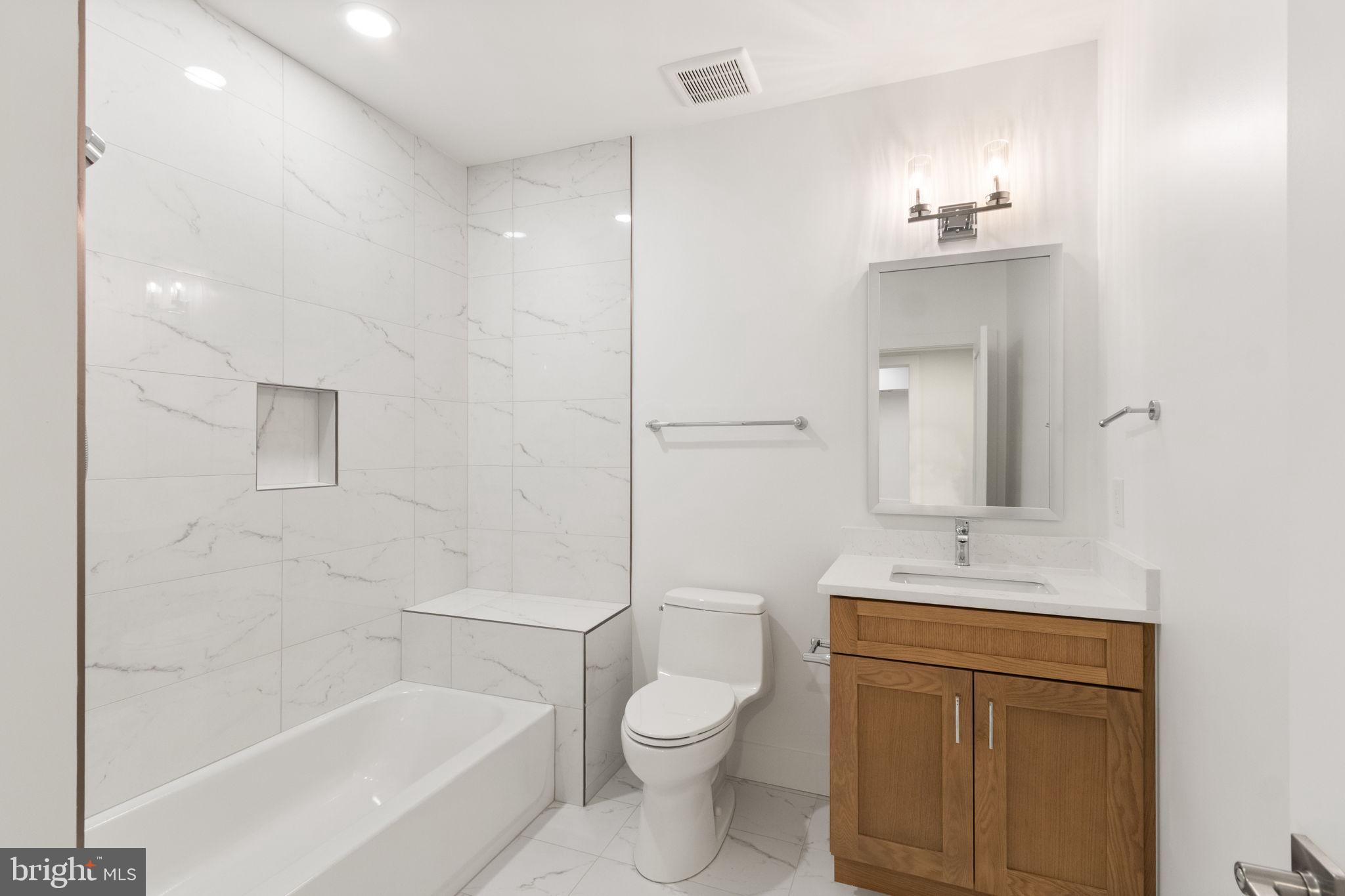 4017 Woodland Road Annandale, VA 22003 - Photo 63 of 76 a bathroom with a sink a toilet and shower