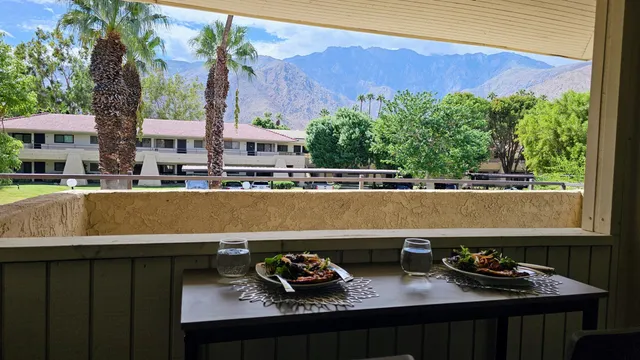 a view of a chairs and table in a balcony