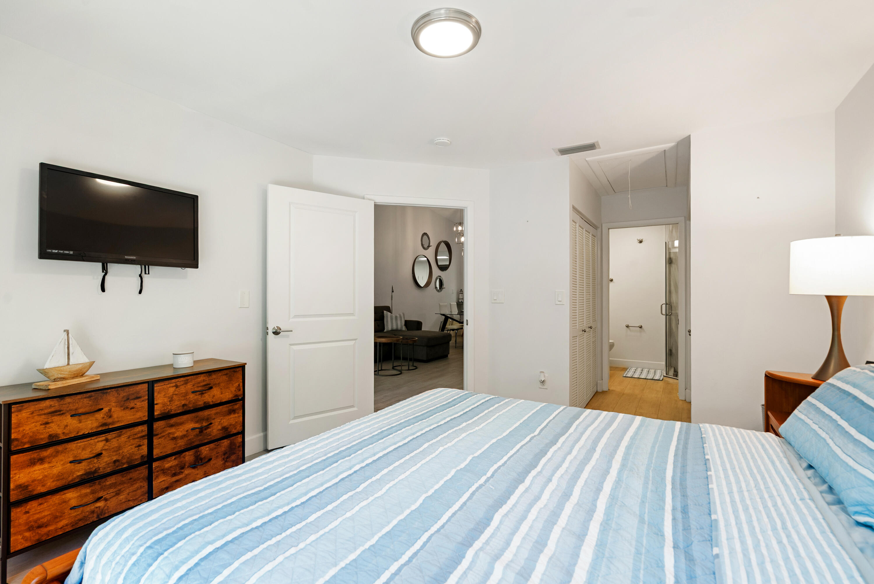 9871 Leeward Avenue Key Largo, FL 33037 - Photo 12 of 38 a bedroom with a bed and a flat screen tv