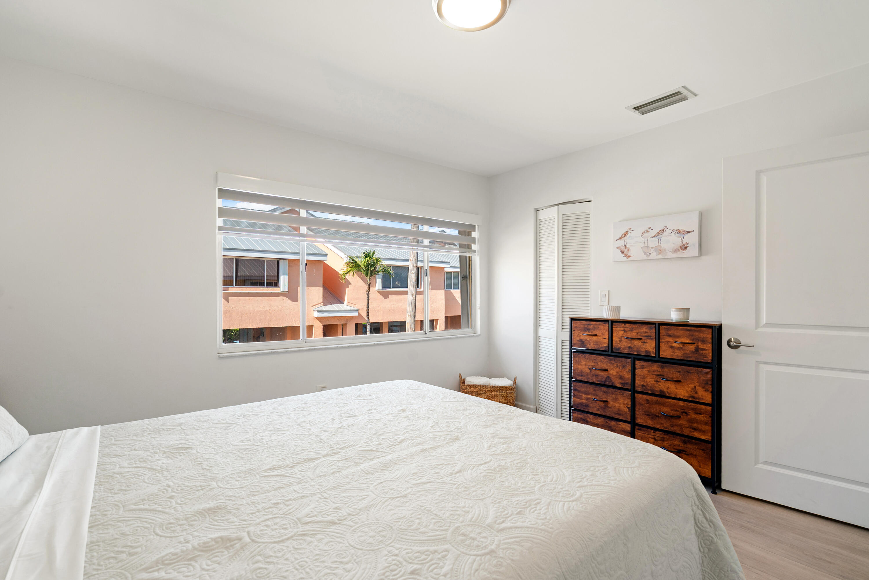 9871 Leeward Avenue Key Largo, FL 33037 - Photo 14 of 38 a bedroom with a bed and a window