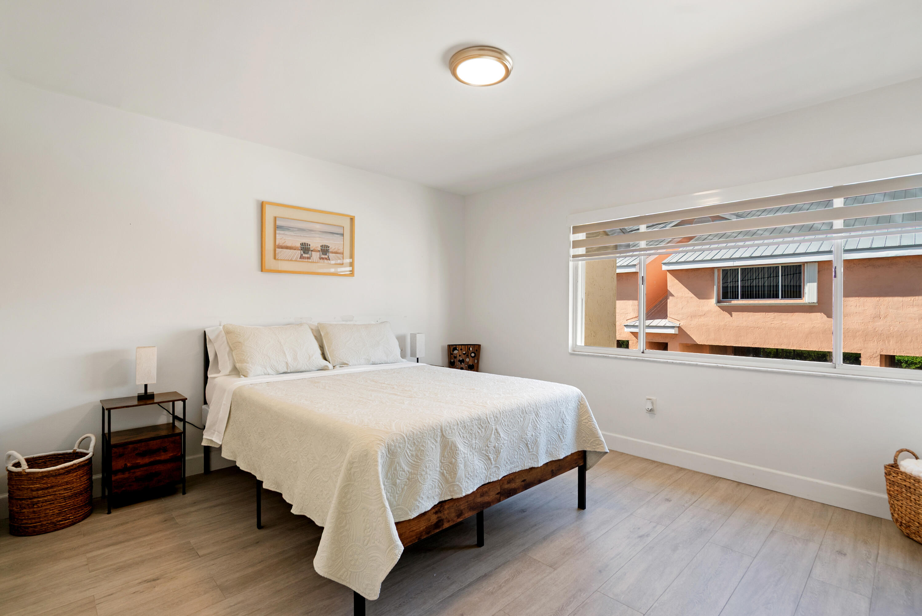 9871 Leeward Avenue Key Largo, FL 33037 - Photo 15 of 38 a bedroom with a bed and wooden floor