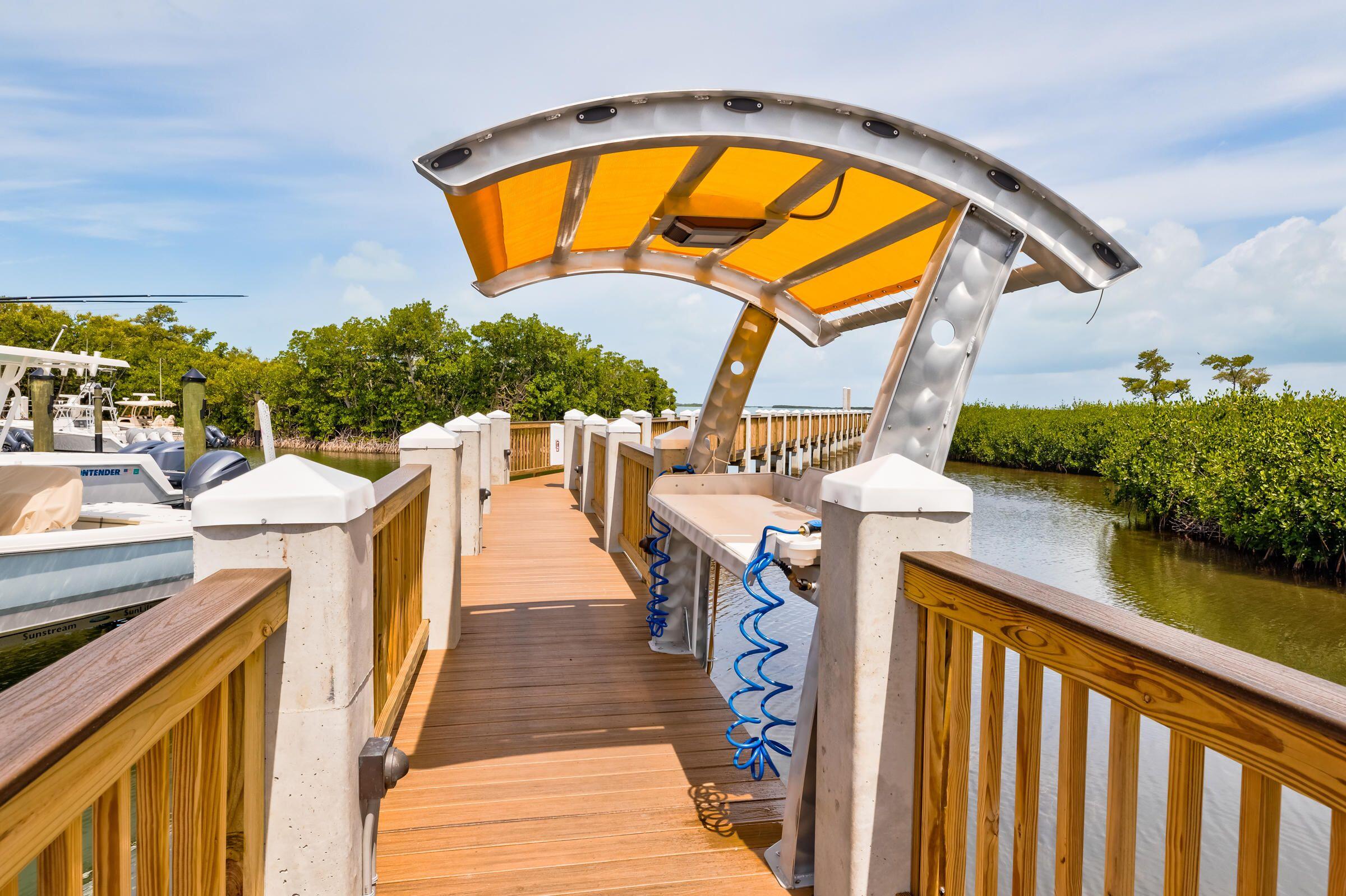 9871 Leeward Avenue Key Largo, FL 33037 - Photo 35 of 38 a view of a swimming pools under an umbrella