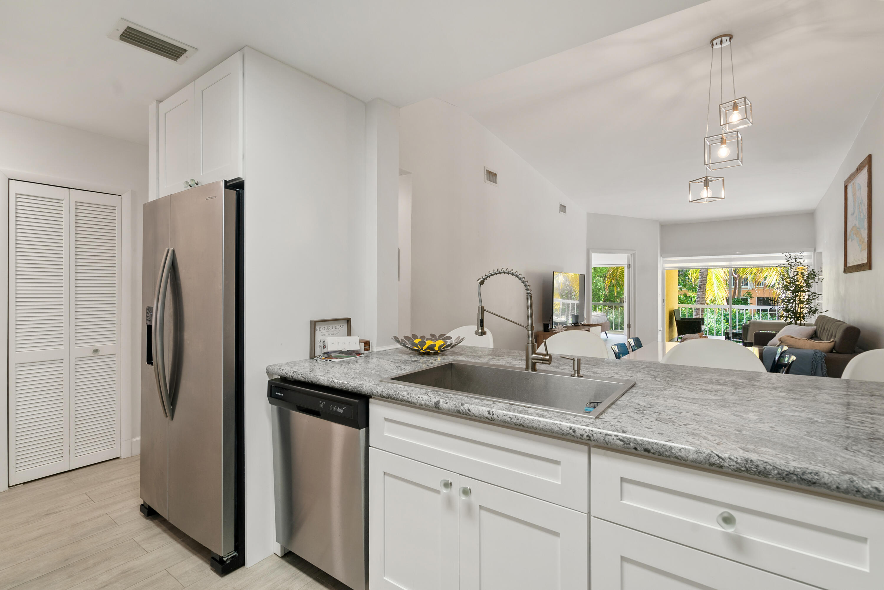 9871 Leeward Avenue Key Largo, FL 33037 - Photo 7 of 38 a kitchen with sink refrigerator and window